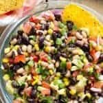 Cowboy Caviar in a glass bowl with tortilla chips