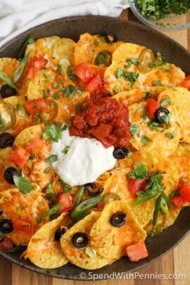 a plate of air fryer nachos with sour cream