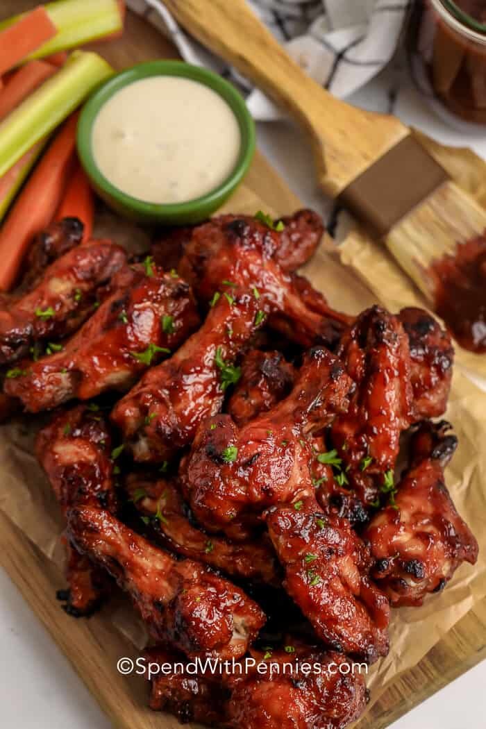 BBQ wings on a wooden board with dip