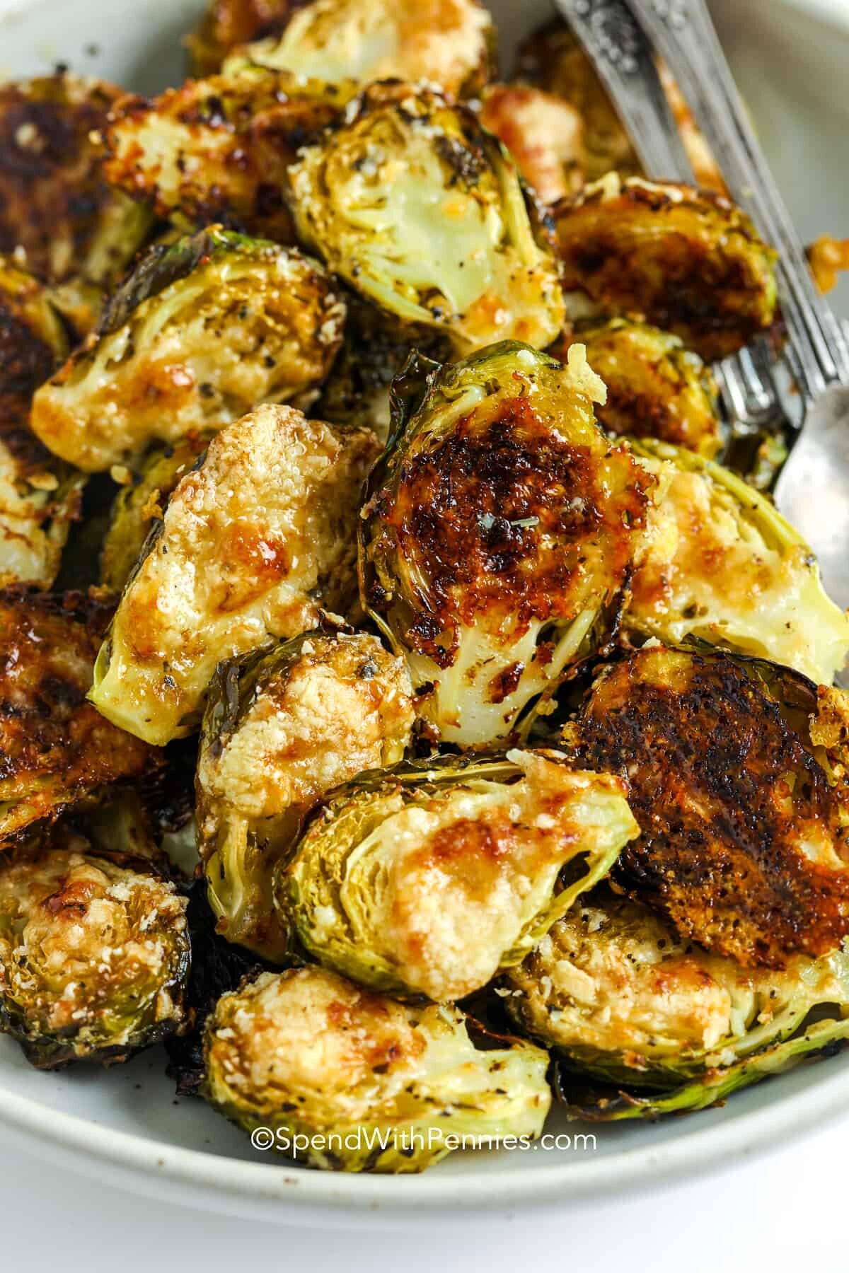 Parmesan Brussel Sprouts in a bowl with utensils