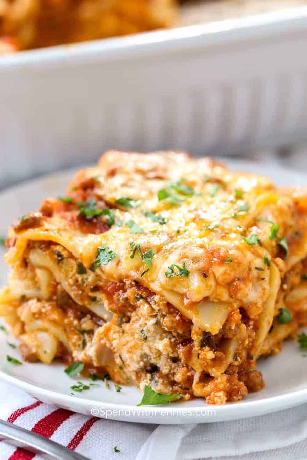 a slice of baked homemade lasagna on a white plate