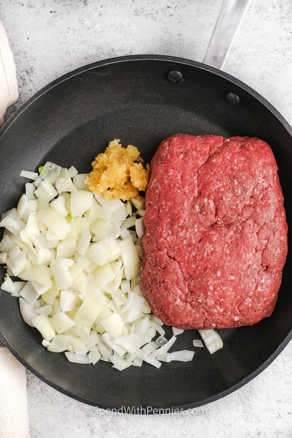 cooking beef with onion and garlic to make Zucchini Lasagna