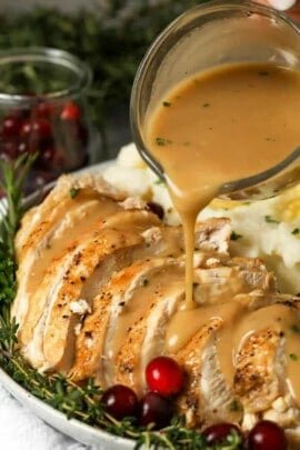 pouring gravy over plated Instant Pot Turkey Breast