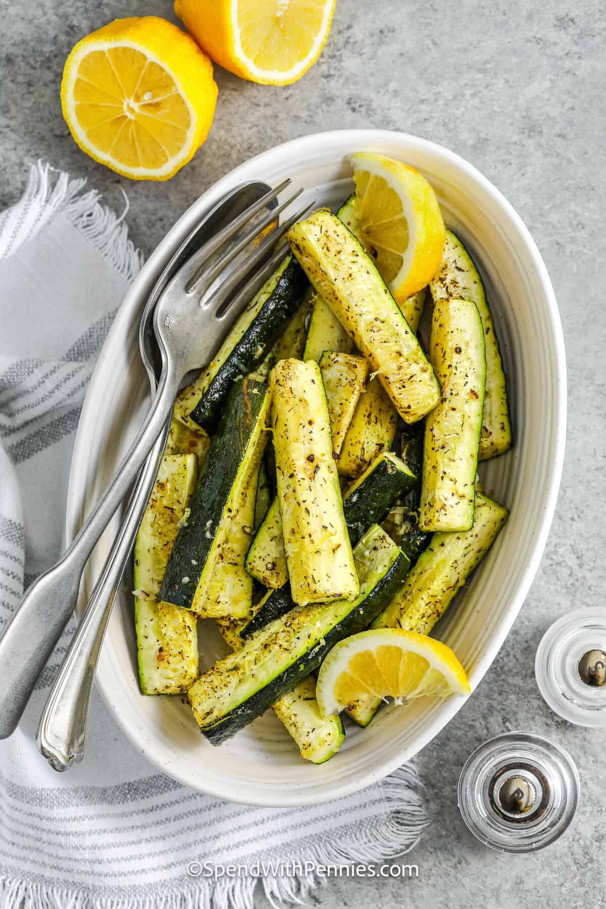 bowl of Easy Roasted Zucchini with lemon slices