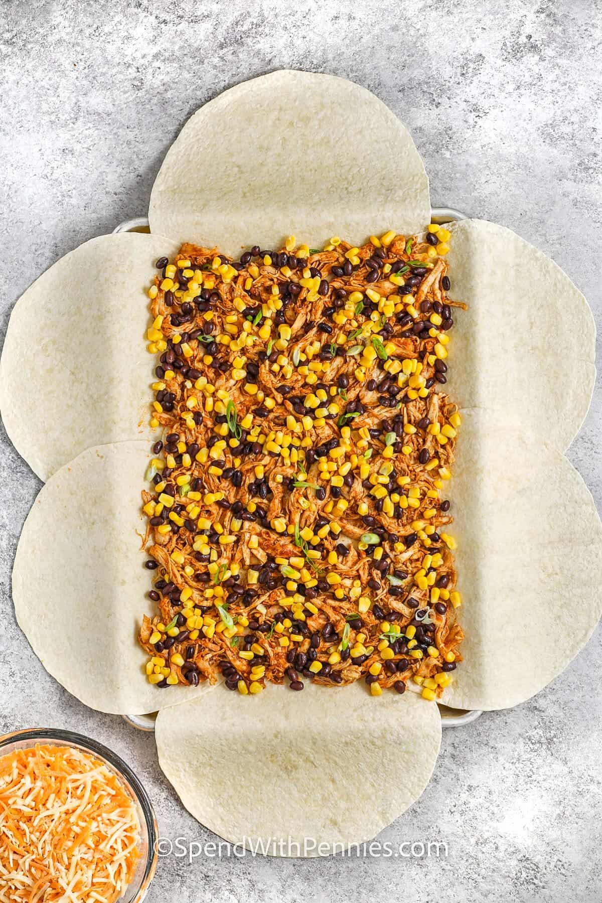 adding corn and bean mixture to Sheet Pan Quesadillas